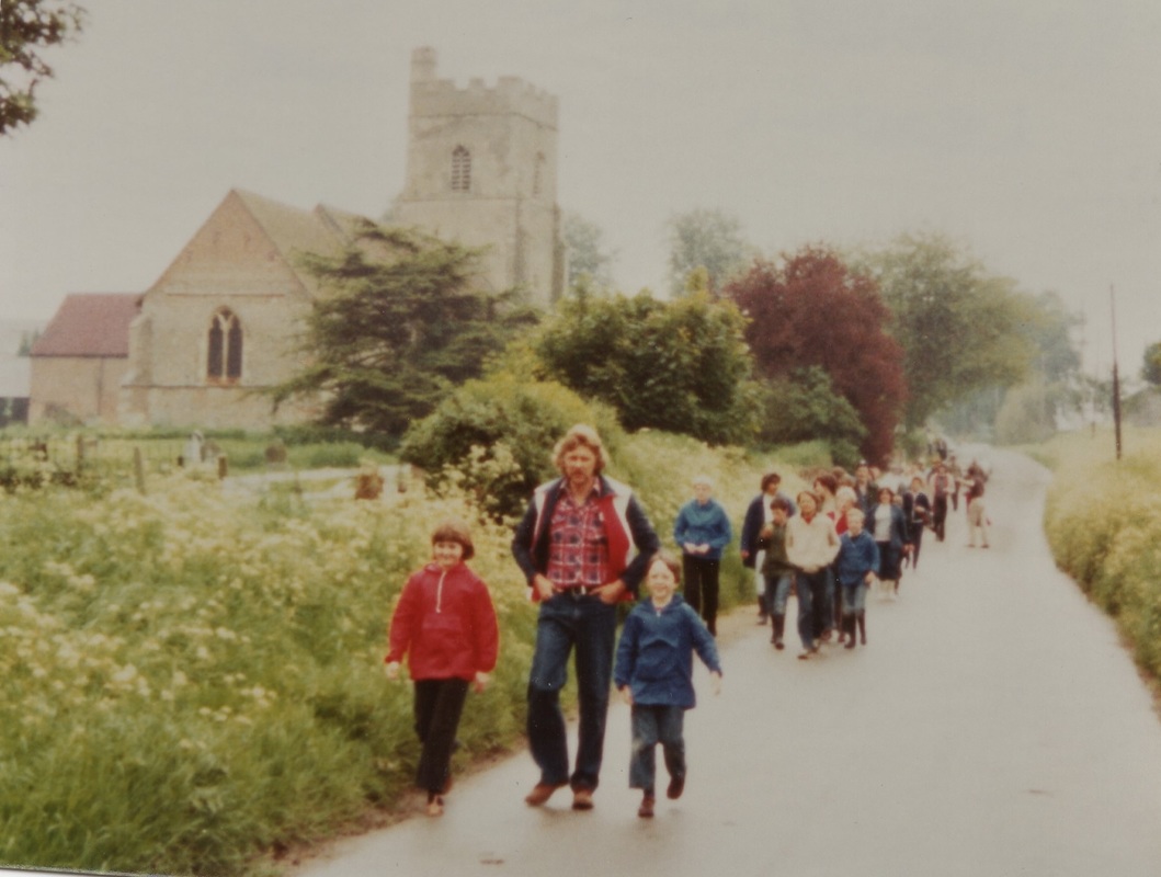 walkers going past the church 